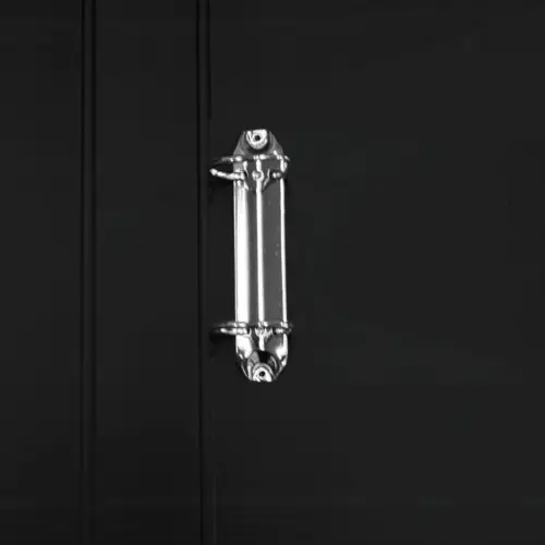 Close-up view of a binder clip attached to a black folder, showcasing its metallic fastener.