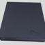 Black rectangular box with the text "MyHome" embossed on it, positioned on a white surface with a slight shadow cast behind it.